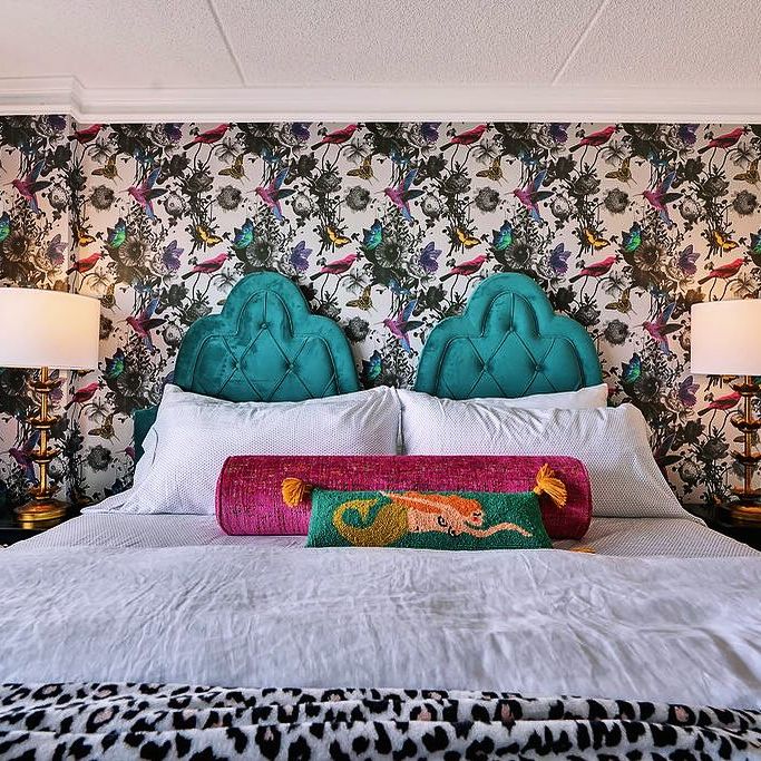 maximalist wallpapered bedroom with teal bed headboard