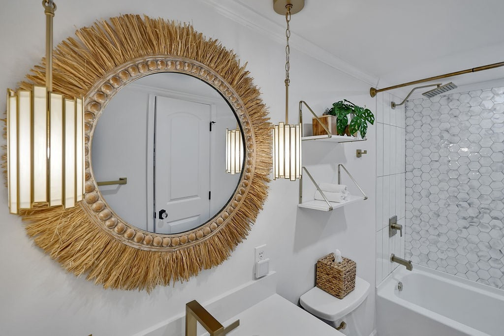 circle frayed mirror in white bathroom