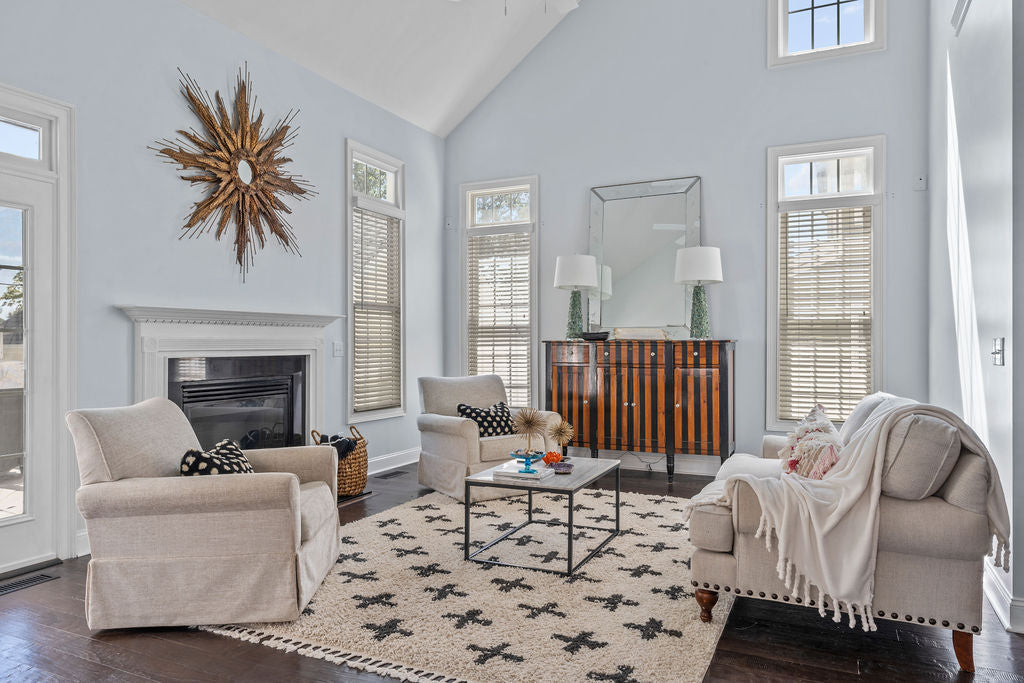 living room black white and gold three chairs and fireplace