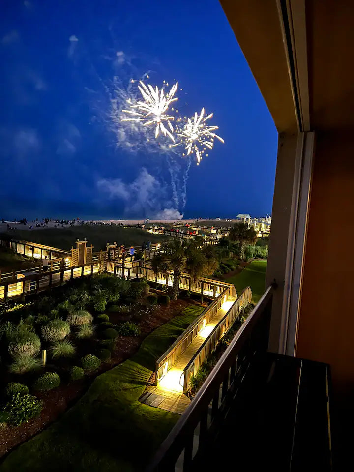 fireworks on carolina beach seen from boardwalk bungalow balcony